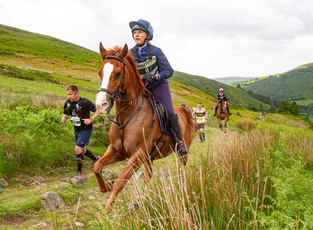 Horse and rider and runners on the Man V Horse course