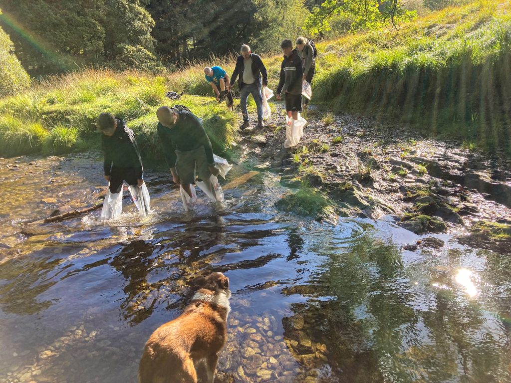 Walkers crossing a stream