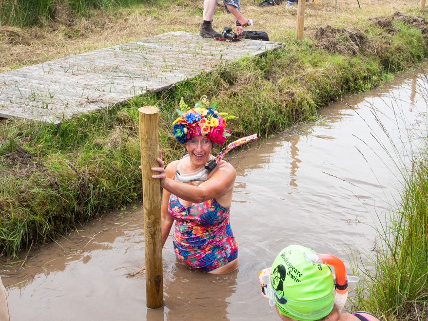Woman with flower headdress bog snorkelling