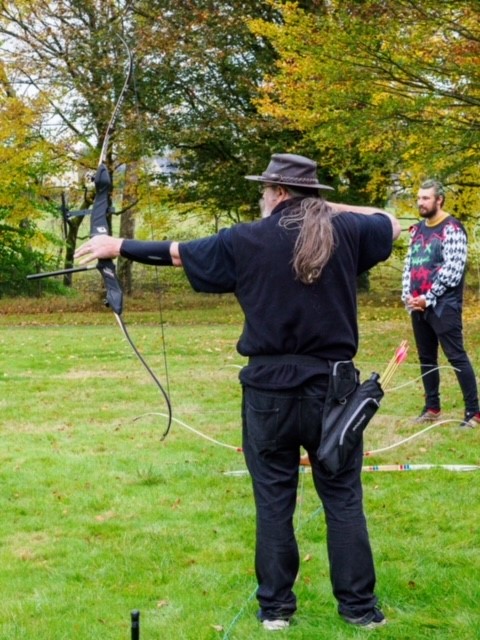 Male archer taking aim with bow