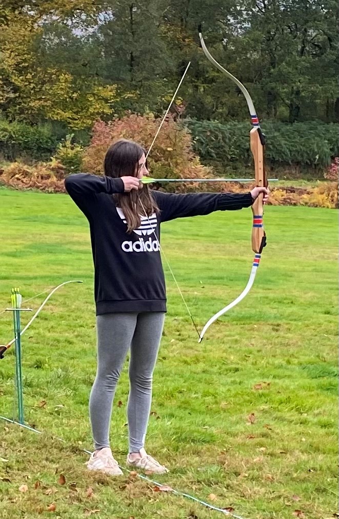 Female archer taking aim with the bow